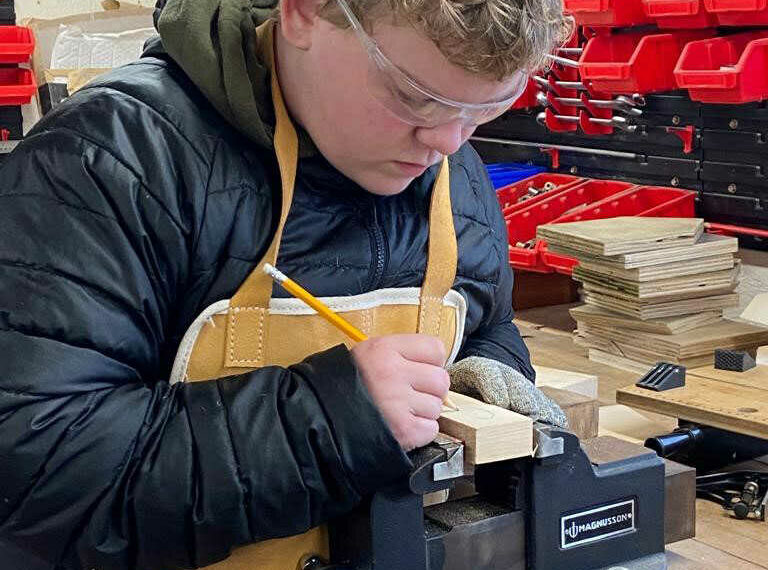 student doing wood work